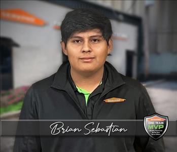 SERVPRO technician in front of SERVPRO office background