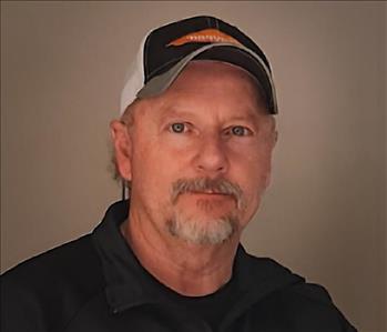 SERVPRO technician standing in front of a wall